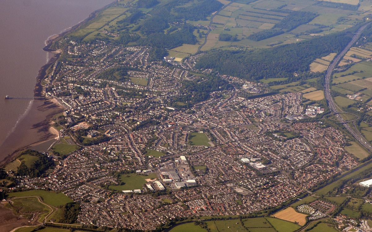 Aerial view of Clevedon, North Somerset, between the Severn Estuary shore and green fields and wooded hills
