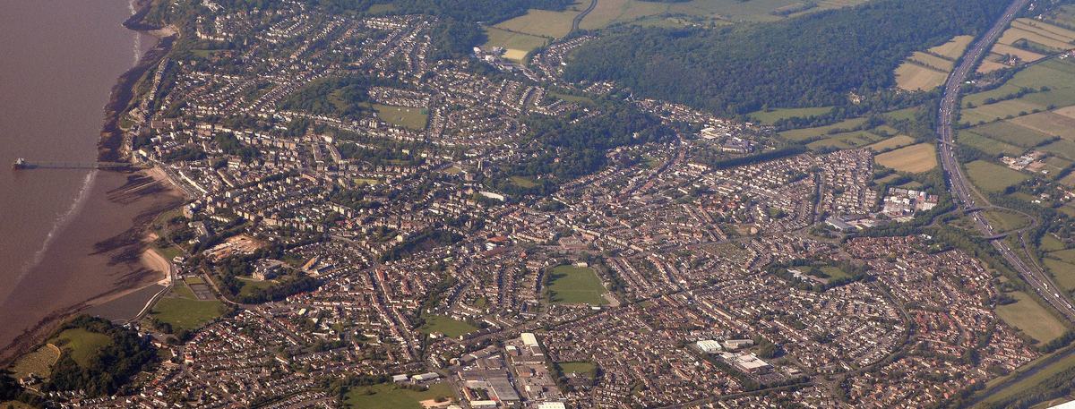 Aerial view of Clevedon, North Somerset, between the Severn Estuary shore and green fields and wooded hills
