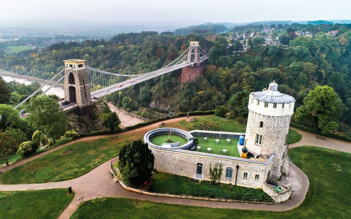 Aerial view of Clifton Suspension Bridge over the Avon Gorge, with Clifton Observatory in the foreground, Bristol