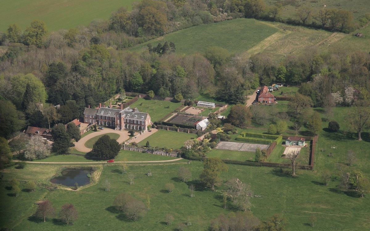 Aerial view of Harrington Hall, a red-brick country house with walled gardens and parkland in Lincolnshire