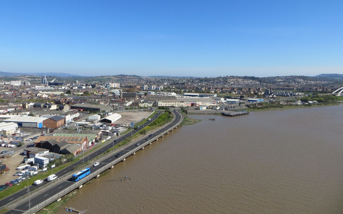 High view from Newport Transporter Bridge along the River Usk towards Newport city centre under a clear blue sky